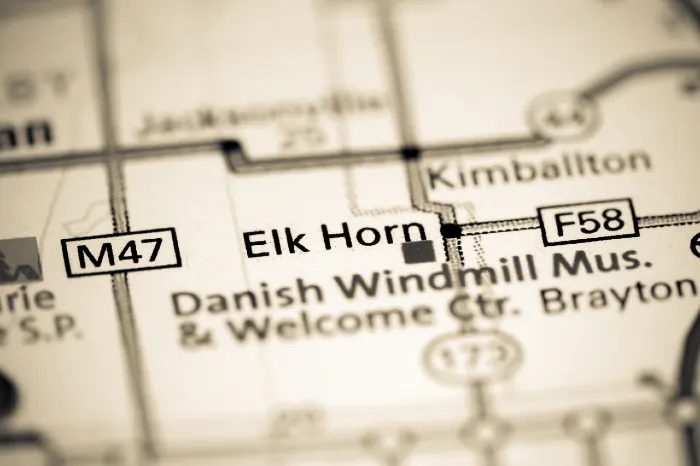 Close-up of a sepia-toned map highlighting Elk Horn, Danish Windmill Museum, and road markers M47 and F58.