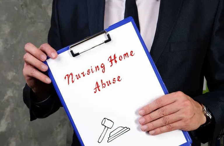 Person in dark suit holding clipboard with text "Nursing Home Abuse" and gavel illustration.